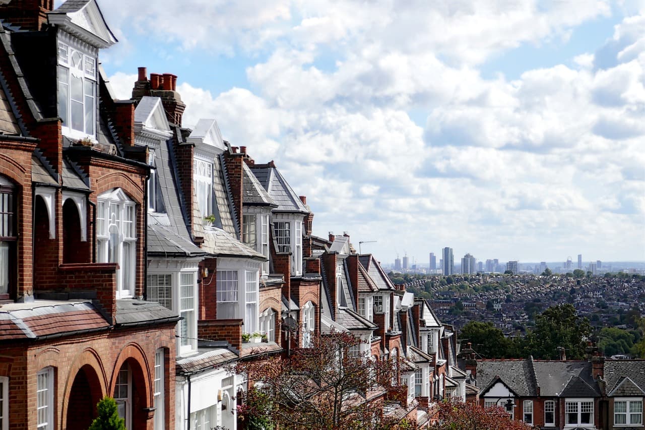 Red-brick Edwardian houses running downhill, with the London skyline in the distance